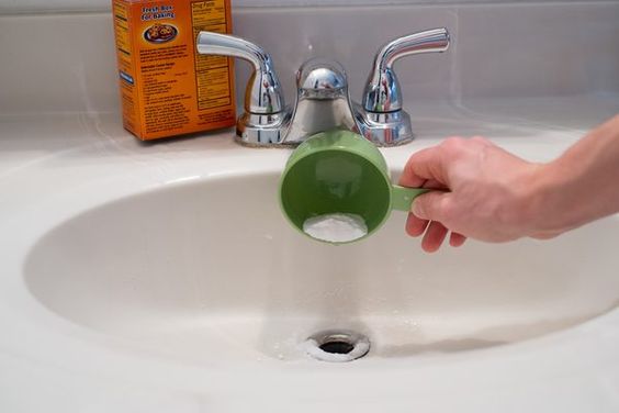 Pour baking soda into bathroom sink